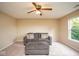Well-lit living room features plush seating and ceiling fan at 8047 Red Barn Cir, Indianapolis, IN 46239