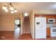 Open-concept living space with stairs, kitchen view, and wood-look floors at 8047 Red Barn Cir, Indianapolis, IN 46239