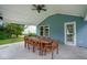 Covered outdoor patio with ample seating, providing a comfortable space next to the house at 8047 Red Barn Cir, Indianapolis, IN 46239