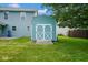 Shed in the backyard with white trim, light blue siding and a wooden ramp at 8047 Red Barn Cir, Indianapolis, IN 46239