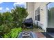Backyard area with a fire pit, grill, foliage, and a sliding glass door at 9525 Longwell Dr, Indianapolis, IN 46240