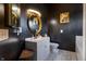 Elegant bathroom with black walls, a round gold mirror, and marble tile flooring, creating a luxurious feel at 9525 Longwell Dr, Indianapolis, IN 46240
