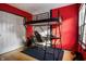Unique bedroom featuring a lofted bed with study space, set against vibrant red walls for a playful touch at 9525 Longwell Dr, Indianapolis, IN 46240