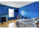 Blue bedroom with natural light featuring a bed, a desk and a window view at 9525 Longwell Dr, Indianapolis, IN 46240