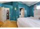 Spacious bedroom with an ensuite and walk-in closet featuring a comfortable bed and bright blue walls at 9525 Longwell Dr, Indianapolis, IN 46240