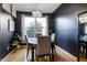 Elegant dining room with dark walls, light hardwood floors and contemporary light fixture at 9525 Longwell Dr, Indianapolis, IN 46240