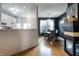 Open dining area with a modern chandelier, dark accent wall, and hardwood flooring, adjacent to the kitchen at 9525 Longwell Dr, Indianapolis, IN 46240
