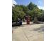 Inviting park area with benches, bike racks, and informational kiosk surrounded by trees, with open sky at 9525 Longwell Dr, Indianapolis, IN 46240