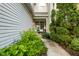 Inviting covered porch with seating area and lush greenery, creating a private entrance at 9525 Longwell Dr, Indianapolis, IN 46240