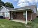 A beautiful brick house with a covered patio area, offering a serene and inviting outdoor living space with a view of the green yard at 989 Plaza Dr, Martinsville, IN 46151