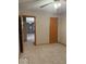 Bedroom view with tan carpet, door to another room, ceiling fan, and tan paint at 989 Plaza Dr, Martinsville, IN 46151