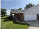 Charming brick home featuring an attached two-car garage and beautifully manicured lawn, creating a welcoming curb appeal at 989 Plaza Dr, Martinsville, IN 46151