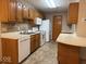 Spacious kitchen features oak cabinets, white appliances, and ample countertop space, perfect for everyday cooking and entertaining at 989 Plaza Dr, Martinsville, IN 46151