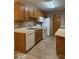 Bright kitchen features oak cabinets, white appliances, and vinyl flooring for a functional cooking space at 989 Plaza Dr, Martinsville, IN 46151