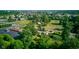 Expansive aerial view of neighborhood showcasing mature trees and green spaces, with nearby community buildings at 10065 E 25Th St, Indianapolis, IN 46229