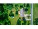 Overhead shot of residence featuring spacious yard, smaller outbuilding, and nearby roadway at 10065 E 25Th St, Indianapolis, IN 46229