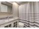 Cozy bathroom featuring a granite countertop and a stylish striped shower curtain at 10065 E 25Th St, Indianapolis, IN 46229