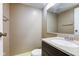 Cozy bathroom with a single sink vanity with dark wood and neutral walls at 10065 E 25Th St, Indianapolis, IN 46229