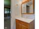 Bathroom featuring a wooden vanity with a sink, a medicine cabinet, and a towel rack at 10065 E 25Th St, Indianapolis, IN 46229