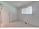 Bright bedroom featuring a window, neutral carpeting and a closet with a door at 10065 E 25Th St, Indianapolis, IN 46229