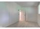 Bright bedroom with neutral carpeting, ample lighting, and access to another room at 10065 E 25Th St, Indianapolis, IN 46229