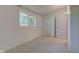Bright bedroom featuring neutral carpeting, ample lighting, and a closet at 10065 E 25Th St, Indianapolis, IN 46229