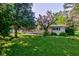 Single story home boasting well-maintained landscaping and mature trees in a charming neighborhood at 10065 E 25Th St, Indianapolis, IN 46229