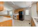 A spacious kitchen with essential appliances, wood cabinetry and bright countertops at 10065 E 25Th St, Indianapolis, IN 46229