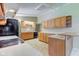 Bright kitchen with light countertops, wooden cabinetry, and essential appliances at 10065 E 25Th St, Indianapolis, IN 46229