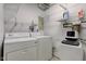 Bright laundry room featuring a washer, dryer, and ample shelving for storage at 10065 E 25Th St, Indianapolis, IN 46229