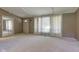 Spacious living room with neutral decor, plush carpeting, and great natural light at 10065 E 25Th St, Indianapolis, IN 46229