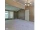 Open living room with large window, neutral walls, and a contemporary light fixture at 10065 E 25Th St, Indianapolis, IN 46229