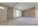Bright living room with large windows, neutral carpeting, and a welcoming atmosphere at 10065 E 25Th St, Indianapolis, IN 46229