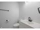 A modern bathroom with white vanity, toilet, and contrasting black faucet, towel bar and toilet paper holder at 10222 Arapahoe Dr, Indianapolis, IN 46235