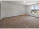 Spacious bedroom with plush carpet and a bright window view at 10222 Arapahoe Dr, Indianapolis, IN 46235