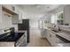 Updated kitchen featuring white cabinets, granite countertops, stainless steel appliances and an open floor plan at 10222 Arapahoe Dr, Indianapolis, IN 46235