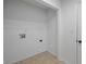 Utility room featuring ceramic tile flooring, washer/dryer hookups, and white walls at 10222 Arapahoe Dr, Indianapolis, IN 46235