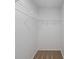 A walk-in closet with carpet flooring and wire shelving for organized storage at 10222 Arapahoe Dr, Indianapolis, IN 46235