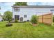 Expansive backyard featuring a deck, garden, new fence, and fire pit area at 1106 Barbara Dr, Greenwood, IN 46143
