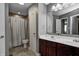 Spacious bathroom with a double sink vanity, a large mirror, and a shower-tub combo, providing comfort and functionality at 1106 Barbara Dr, Greenwood, IN 46143