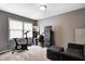 Versatile flex room featuring neutral tones, a stationary bike, and a cozy sitting area for fitness and relaxation at 1106 Barbara Dr, Greenwood, IN 46143