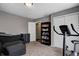 The versatile flex room is staged with exercise equipment and a couch to show the room's adaptability at 1106 Barbara Dr, Greenwood, IN 46143