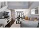 Open-concept living room with dark floors, a comfortable sofa, and a view into the dining area at 1106 Barbara Dr, Greenwood, IN 46143