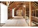 Large unfinished attic with wood beams and flooring, offering potential for expansion at 11250 N 600 W, Fountaintown, IN 46130
