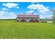 Large red and white barn on a lush green lawn, offering ample space and charm at 11250 N 600 W, Fountaintown, IN 46130