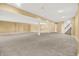 Large, bright basement with neutral walls and carpet, recessed lighting, support columns and staircase access, ideal for entertaining at 11250 N 600 W, Fountaintown, IN 46130