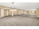 Expansive basement with neutral walls, carpet flooring, bright lighting and columns, perfect for entertaining or recreation at 11250 N 600 W, Fountaintown, IN 46130