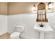 Elegant bathroom with wainscoting, pedestal sink, and a decorative mirror at 11250 N 600 W, Fountaintown, IN 46130