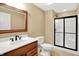 Bathroom featuring wood vanity, framed mirror, toilet, and walk-in shower with glass doors, providing a fresh design at 11250 N 600 W, Fountaintown, IN 46130