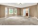 Large bedroom with bay windows, neutral paint, and a bathroom entrance at 11250 N 600 W, Fountaintown, IN 46130